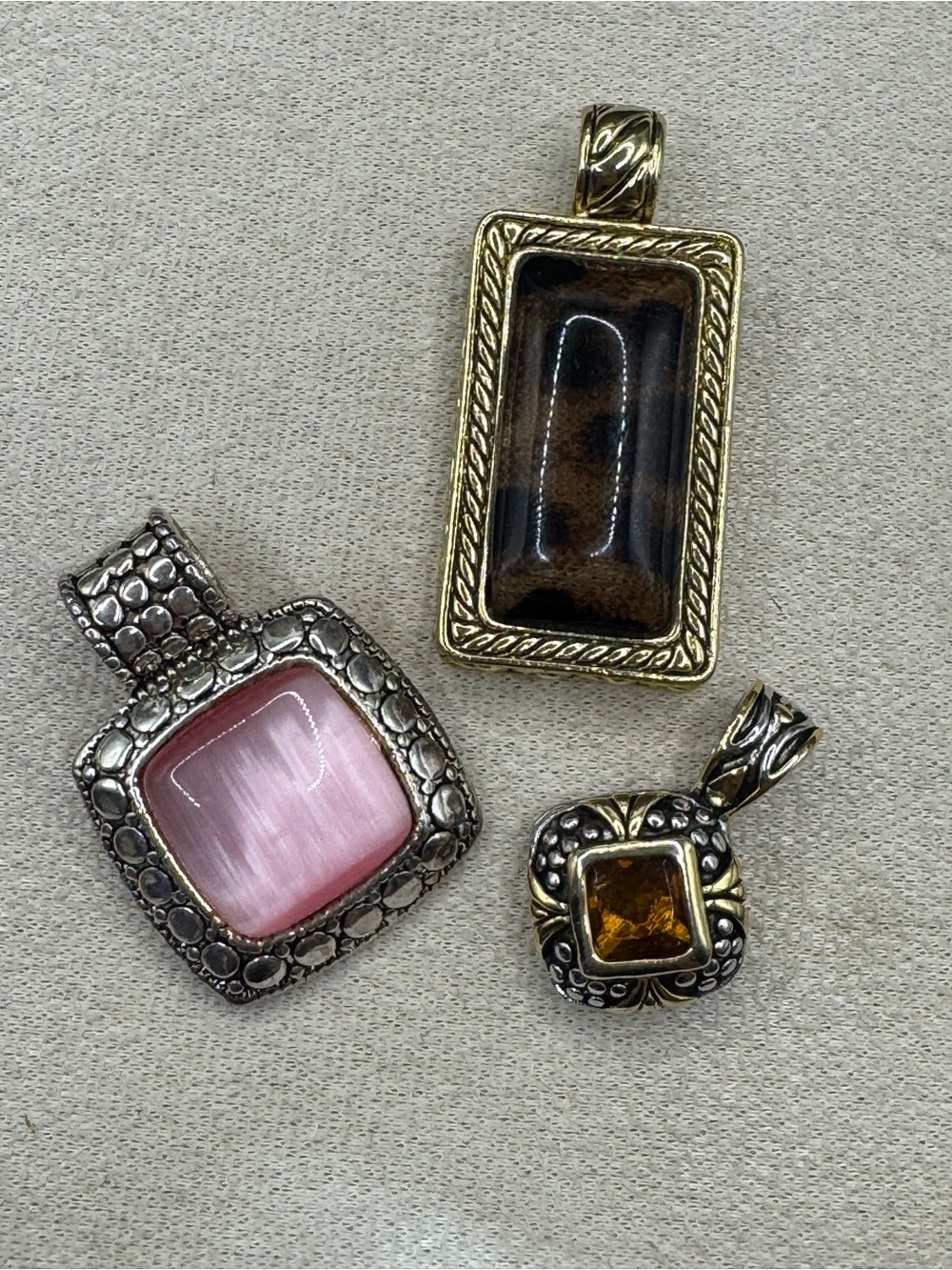 3 costume jewelry pendants with imitation stones & silver/gold metal details.